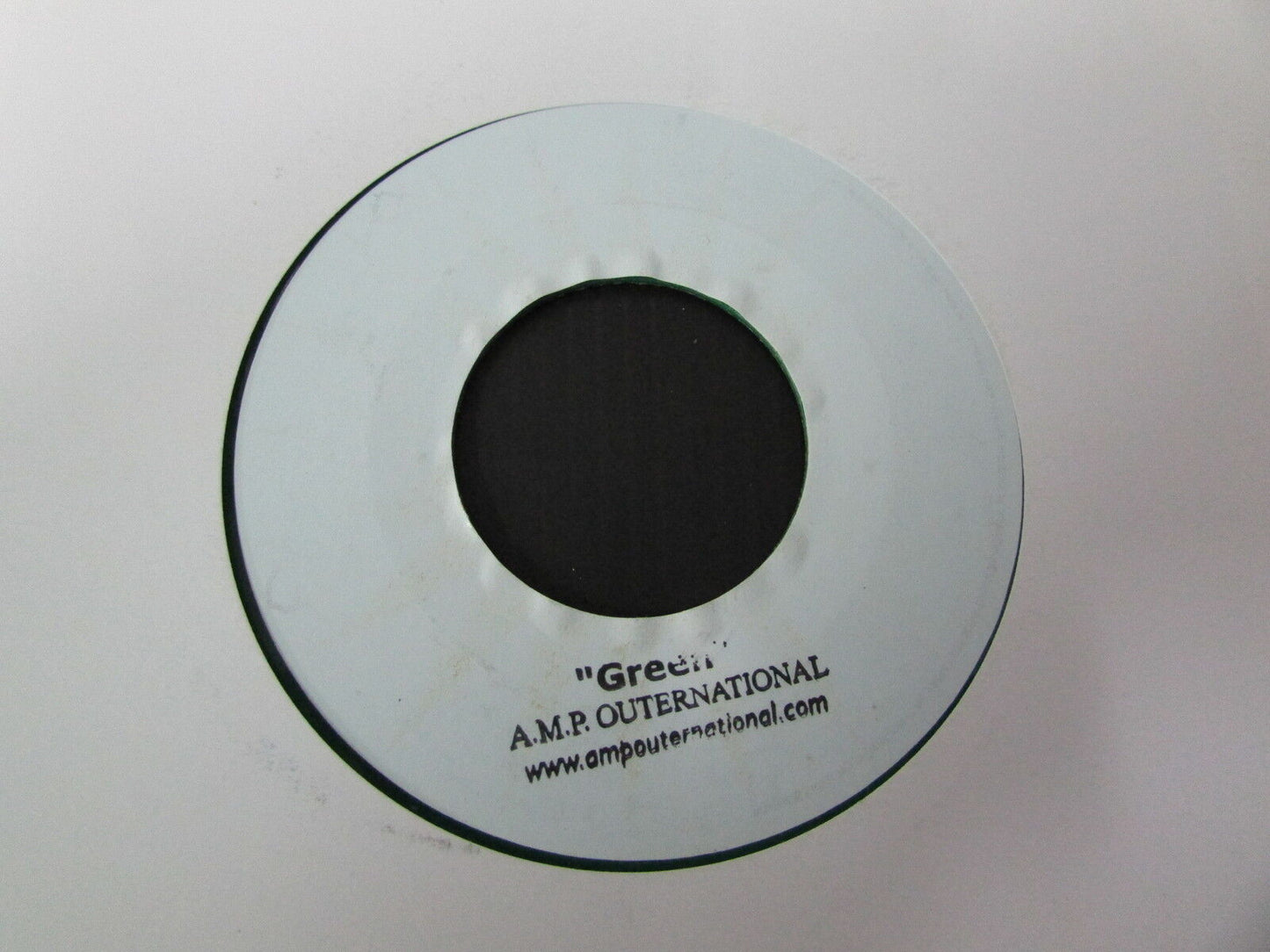 A.M.P. OUTERNATIONAL SP 45T 7" GREEN GREEN VINYL
